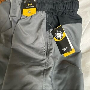 NWT - Speedo swim trunks - grey with black trim 20” out seam, mesh liner Size XL